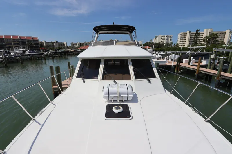 Fitz Perfectly Yacht Photos Pics 2001 Navigator 4800 CLASSIC yacht docked in a marina with clear blue skies.