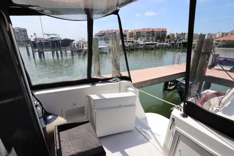 Fitz Perfectly Yacht Photos Pics 2001 Navigator 4800 CLASSIC yacht interior with marina view, featuring seating and storage.