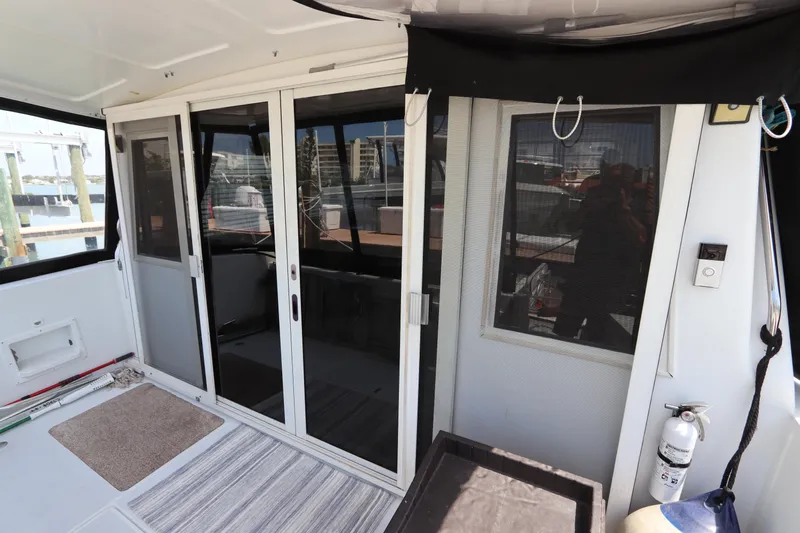 Fitz Perfectly Yacht Photos Pics Interior view of 2001 Navigator 4800 CLASSIC yacht with sliding glass doors and striped rug.