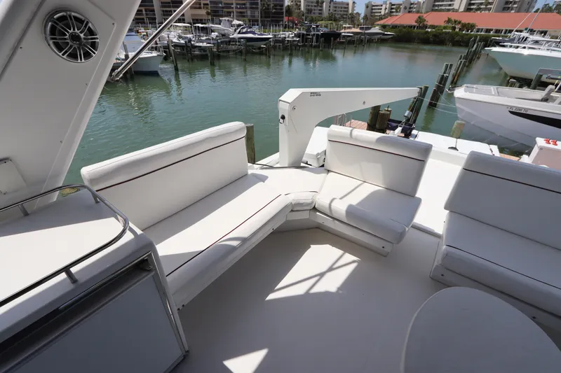 Fitz Perfectly Yacht Photos Pics 2001 Navigator 4800 CLASSIC yacht with white seating, docked in a marina.