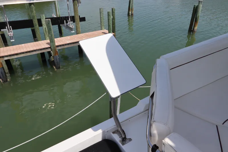 Fitz Perfectly Yacht Photos Pics Navigator 4800 CLASSIC 2001 boat with white seating and table, docked by wooden piers.