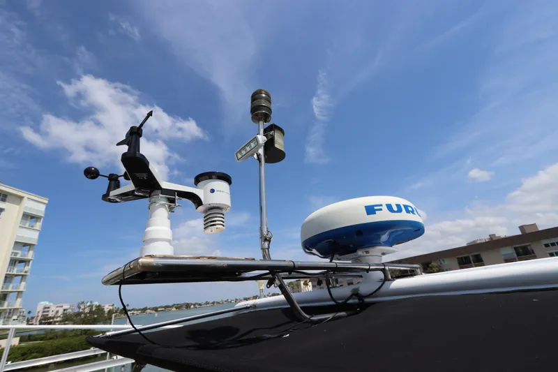 Fitz Perfectly Yacht Photos Pics Weather instruments and radar on Navigator 4800 CLASSIC yacht, 2001 model, under a clear blue sky.