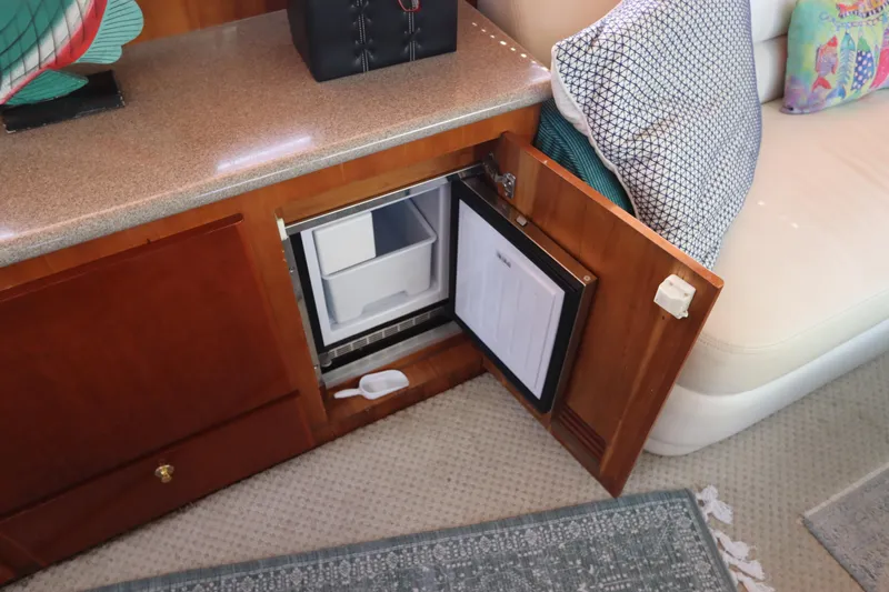 Fitz Perfectly Yacht Photos Pics Open mini fridge in 2001 Navigator 4800 CLASSIC yacht interior.