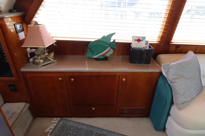 Fitz Perfectly Yacht Photos Pics Interior of 2001 Navigator 4800 Classic yacht with wooden cabinetry and decorative items.