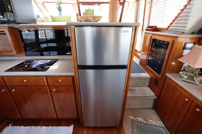 Fitz Perfectly Yacht Photos Pics Modern kitchen interior on 2001 Navigator 4800 CLASSIC yacht with stainless steel appliances.
