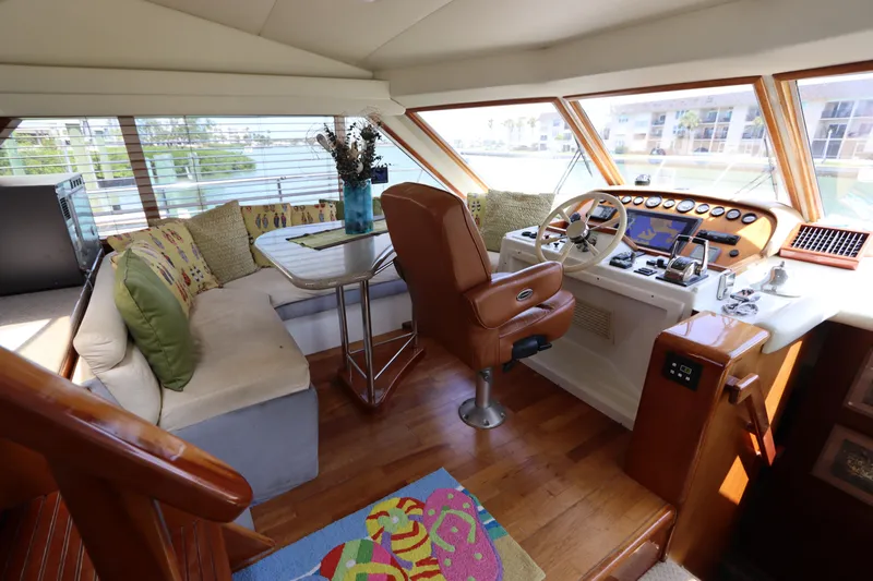 Fitz Perfectly Yacht Photos Pics Luxurious interior of 2001 Navigator 4800 CLASSIC yacht with helm, seating, and panoramic windows.