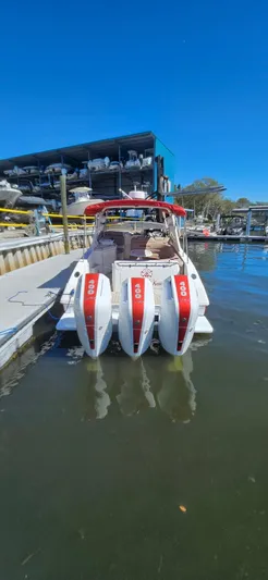  Yacht Photos Pics 2006 Fountain 38 Express Cruiser with triple outboard engines docked at marina.