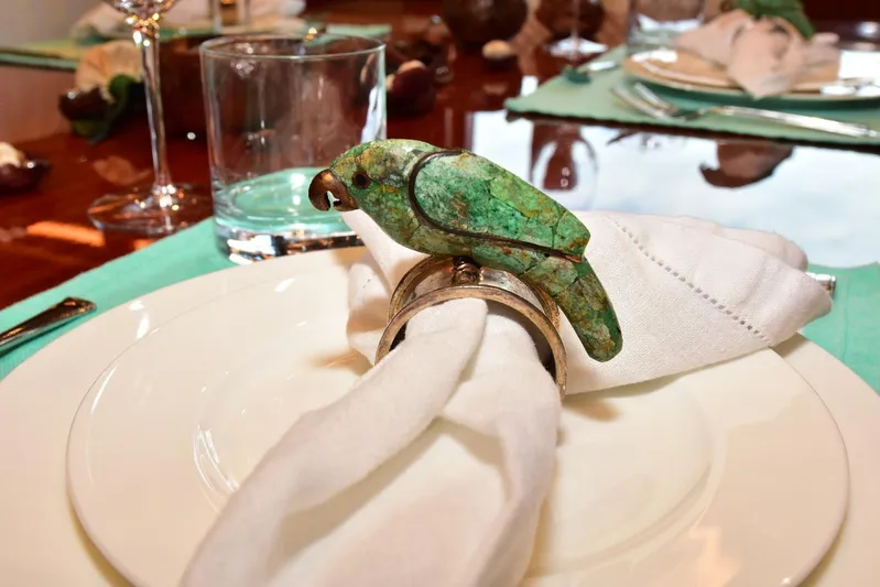 Renaissance Yacht Photos Pics Elegant dining setup on Hargrave 116 RPH yacht, featuring parrot napkin ring.