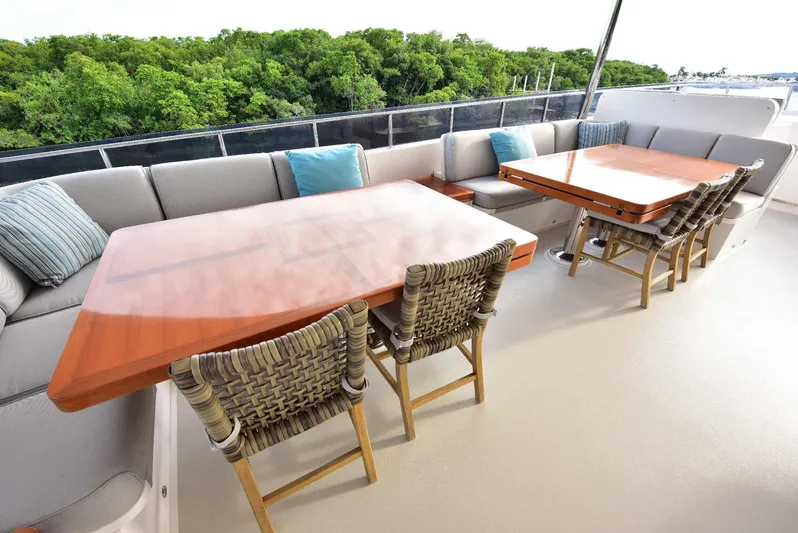 Renaissance Yacht Photos Pics Luxurious outdoor seating on 2016 Hargrave 116 RPH yacht with wooden tables and cushioned chairs.