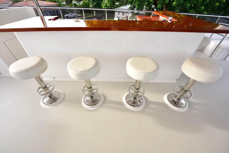 Renaissance Yacht Photos Pics Four white bar stools on a 2016 Hargrave 116 RPH yacht deck.