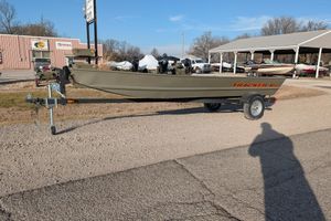 2025 Tracker Grizzly 15 Jon boat on trailer in outdoor dealership setting.