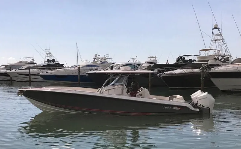  Yacht Photos Pics 2015 Nor-Tech 340 Sport boat docked in marina, surrounded by luxury yachts.
