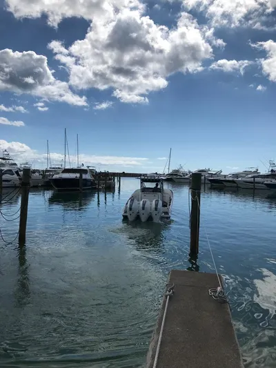  Yacht Photos Pics 2015 Nor-Tech 340 Sport boat docked in a sunny marina with scattered clouds.