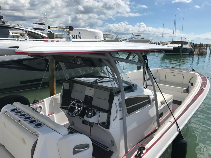  Yacht Photos Pics 2015 Nor-Tech 340 Sport boat docked, featuring a sleek design and modern navigation equipment.