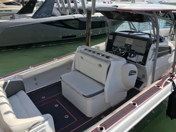  Yacht Photos Pics 2015 Nor-Tech 340 Sport boat interior with seating and helm, docked in marina.