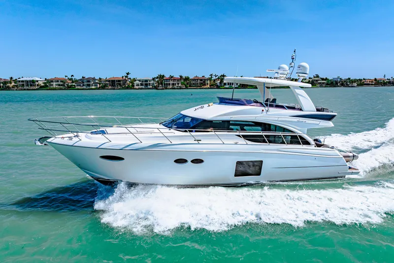 Fuelish Pleasure II Yacht Photos Pics Luxurious 2017 Princess 56 yacht cruising on turquoise waters under clear blue skies.
