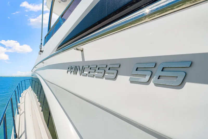 Fuelish Pleasure II Yacht Photos Pics Side view of a 2017 Princess 56 yacht with clear blue sky and ocean.