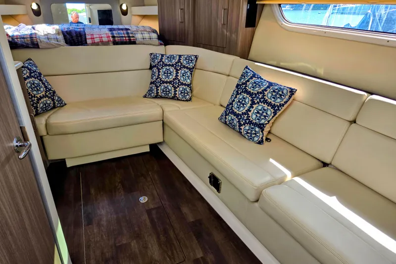 Willowbender Yacht Photos Pics Luxurious interior of 2019 Regal 35 Sport Coupe with beige seating and decorative pillows.