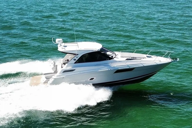 Willowbender Yacht Photos Pics 2019 Regal 35 Sport Coupe cruising on open water, showcasing sleek design and performance.