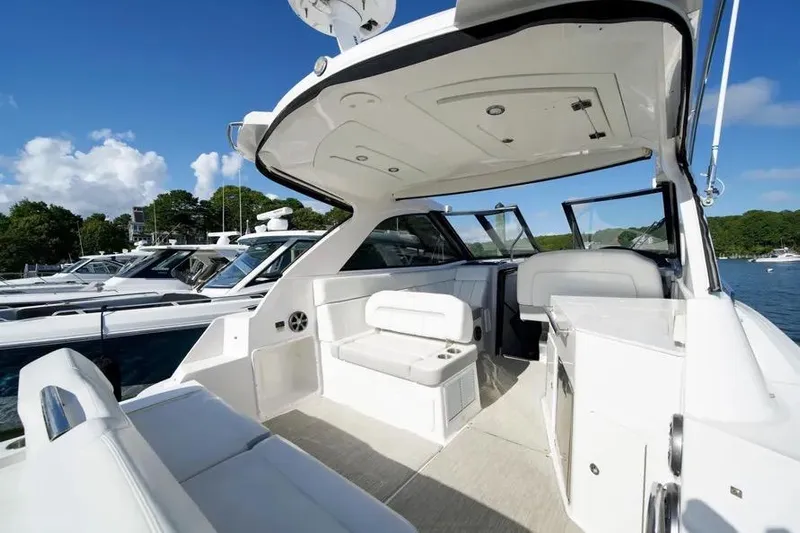 Willowbender Yacht Photos Pics 2019 Regal 35 Sport Coupe yacht interior with seating, docked under clear blue sky.