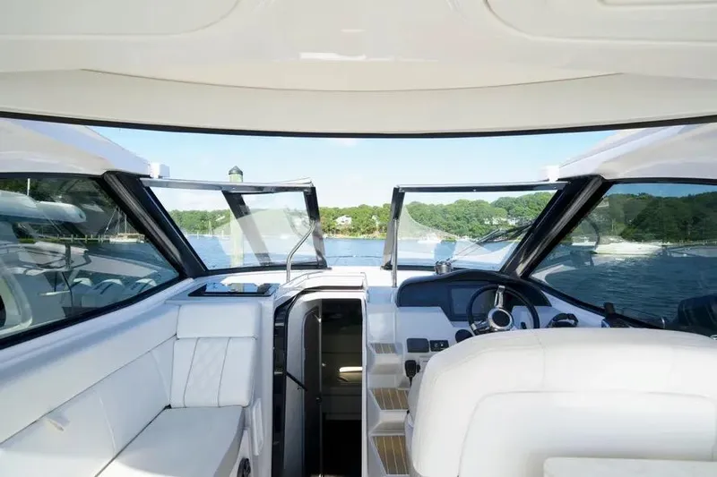 Willowbender Yacht Photos Pics 2019 Regal 35 Sport Coupe cockpit with scenic water view and luxurious seating.