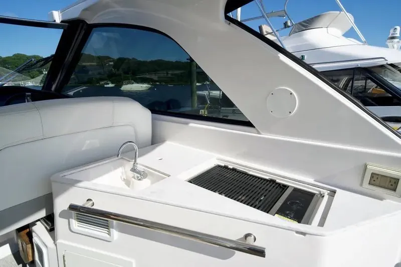 Willowbender Yacht Photos Pics 2019 Regal 35 Sport Coupe yacht interior with sink and grill station.