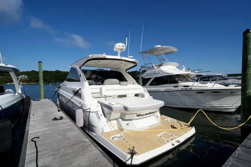 Willowbender Yacht Photos Pics 2019 Regal 35 Sport Coupe docked at marina under clear blue sky.