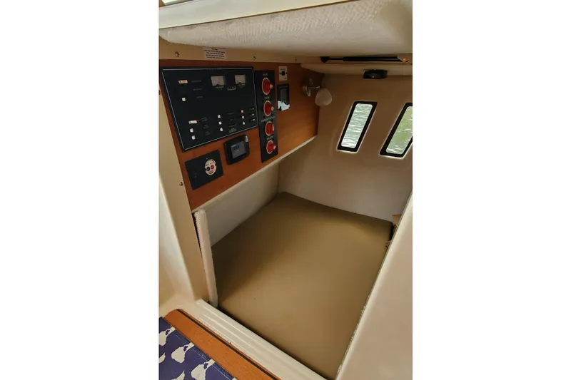 Swell Life Yacht Photos Pics Interior cabin of 2021 Ranger Tugs R-25 boat with control panel and windows.