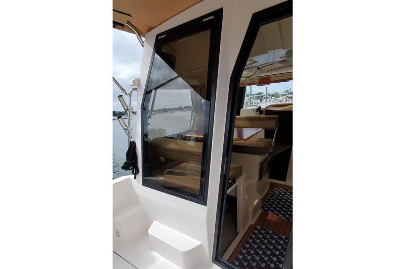 Swell Life Yacht Photos Pics 2021 Ranger Tugs R-25 boat interior view with open door and seating area.