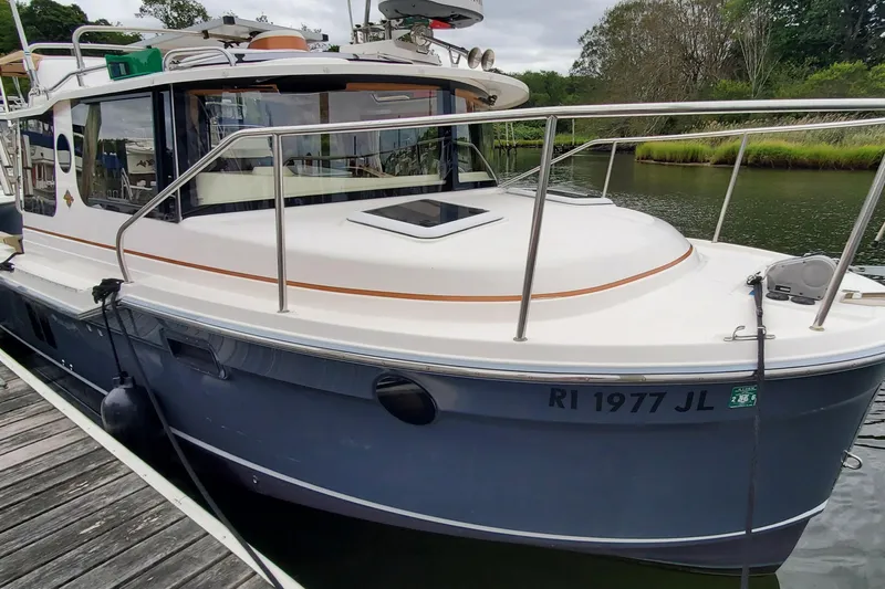 Swell Life Yacht Photos Pics 2021 Ranger Tugs R-25 boat docked, featuring sleek design and modern amenities.