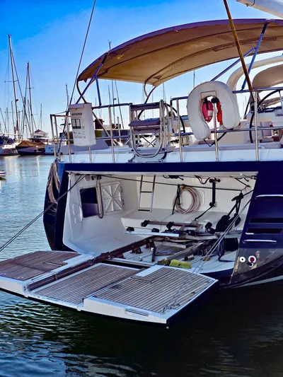 Trois Vignes Yacht Photos Pics 2015 Jeanneau Aft Cockpit yacht with open transom, docked in marina.