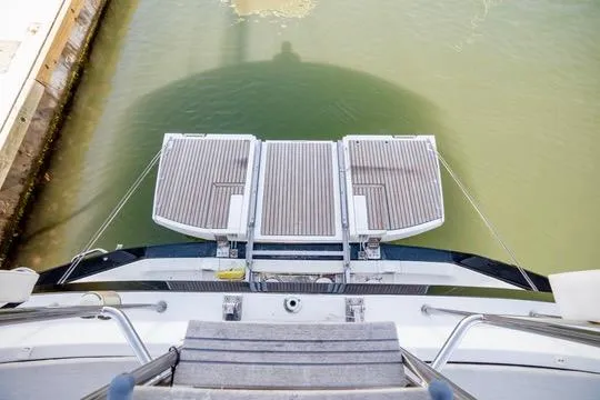 Trois Vignes Yacht Photos Pics 2015 Jeanneau Aft Cockpit yacht with open swim platform on calm water.