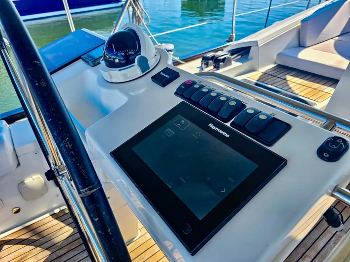 Trois Vignes Yacht Photos Pics 2015 Jeanneau Aft Cockpit helm with navigation controls and compass.