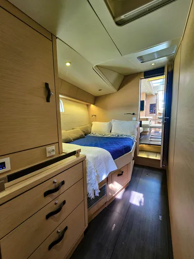 Trois Vignes Yacht Photos Pics 2015 Jeanneau Aft Cockpit interior with cozy bed and wooden cabinetry.