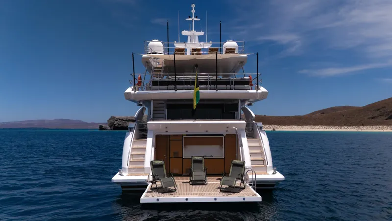  Yacht Photos Pics Azimut Grande 35 Metri 2019 yacht, rear view, anchored in serene blue waters.