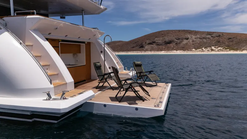  Yacht Photos Pics Luxurious 2019 Azimut Grande 35 Metri yacht with deck chairs, ocean view, and scenic coastline.