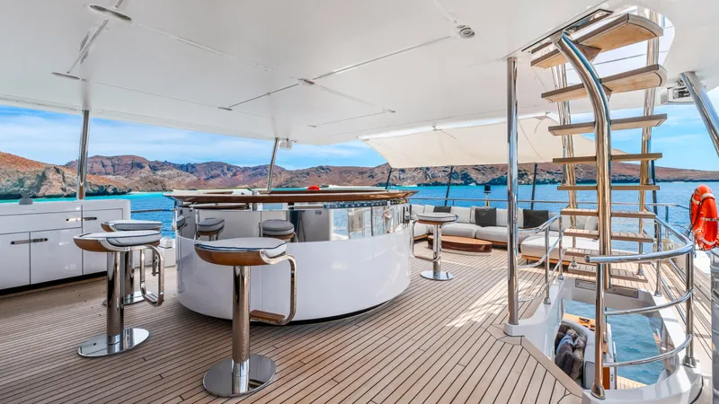  Yacht Photos Pics Luxurious 2019 Azimut Grande 35 Metri yacht deck with bar, seating, and ocean view.