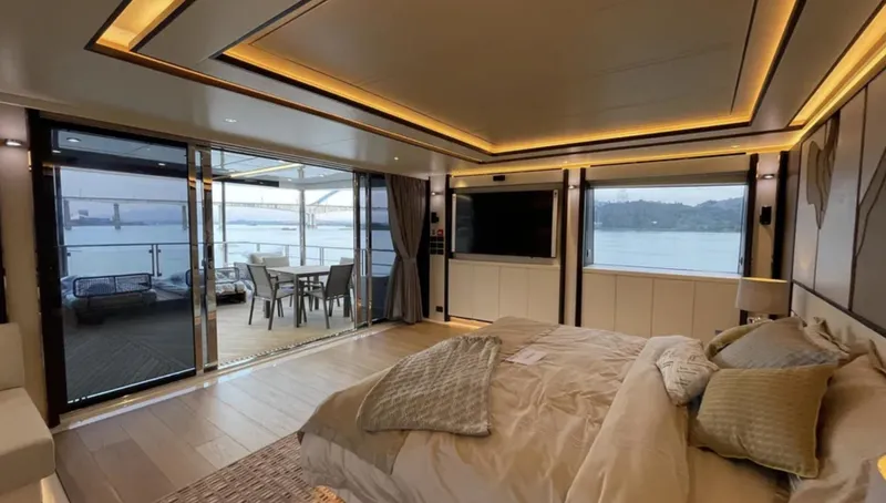  Yacht Photos Pics Luxurious bedroom on 2023 Heysea Asteria 142 yacht with ocean view and modern decor.