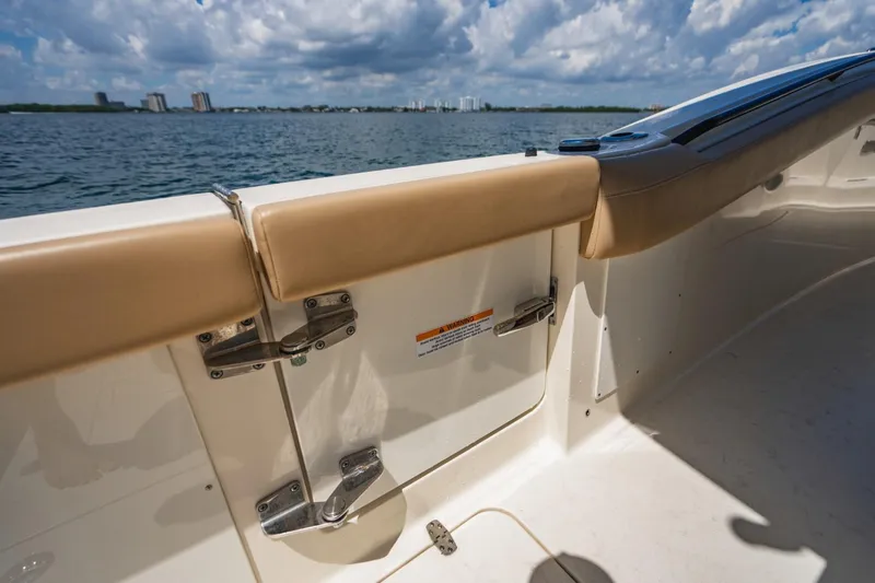  Yacht Photos Pics 2022 Scout 305 LXF boat interior with tan upholstery and ocean view.