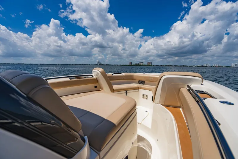  Yacht Photos Pics 2022 Scout 305 LXF boat interior with tan seating on a sunny day.