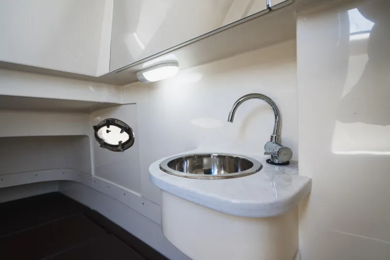  Yacht Photos Pics 2022 Scout 305 LXF boat interior with sink and porthole.