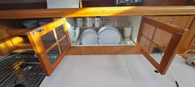 Bashful Yacht Photos Pics 2006 Hunter 46 LE yacht kitchen with open cabinets and dish rack