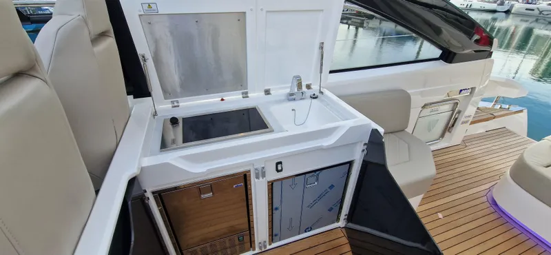 In Stock Yacht Photos Pics 2025 Fairline Targa 45 Open yacht kitchenette with sink and storage, featuring sleek design.
