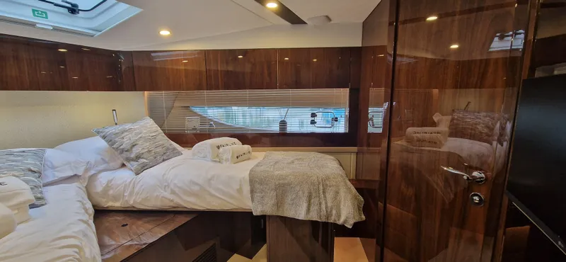 In Stock Yacht Photos Pics Luxurious cabin interior of 2025 Fairline Targa 45 Open yacht, featuring elegant wood finishes.