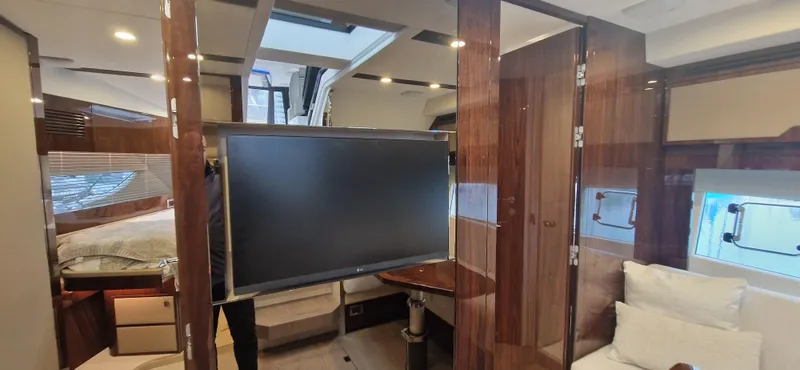 In Stock Yacht Photos Pics 2025 Fairline Targa 45 Open interior with modern design, featuring a TV and luxurious furnishings.