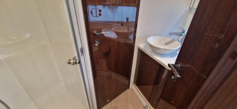 In Stock Yacht Photos Pics 2025 Fairline Targa 45 Open bathroom with modern sink and wooden cabinetry.