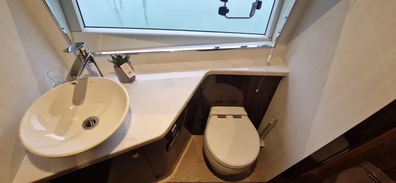 In Stock Yacht Photos Pics Modern bathroom in 2025 Fairline Targa 45 Open yacht with sink and toilet.