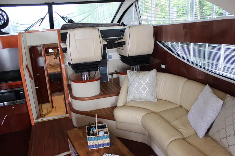  Yacht Photos Pics Interior of a 2006 Fairline Phantom yacht with beige leather seating and modern helm chairs.