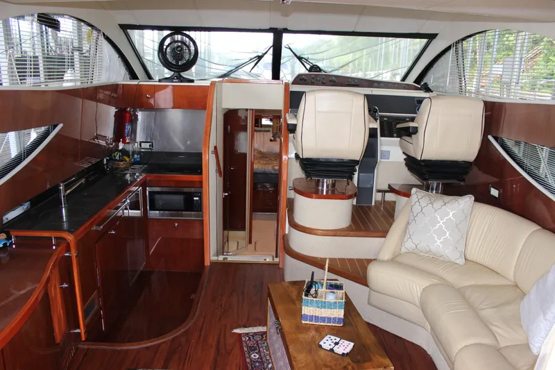  Yacht Photos Pics Interior of 2006 Fairline Phantom yacht with modern kitchen and cozy seating area.