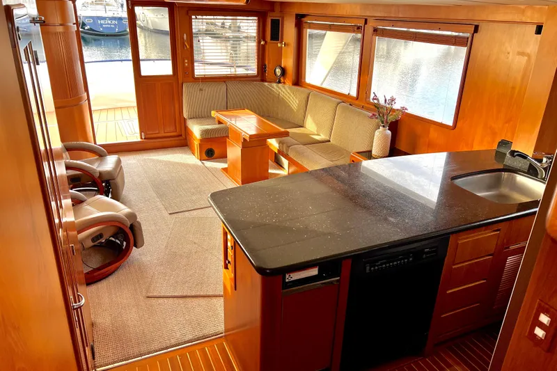 Fellowship Yacht Photos Pics Luxurious 2001 Grand Alaskan Pilothouse interior with elegant wood finishes and modern amenities.